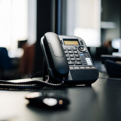 Office telephone on dark desk